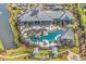 Aerial view of a luxury community pool surrounded by palm trees, cabanas, and manicured lawns at 7205 Spoleto Dr., Myrtle Beach, SC 29572