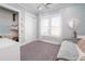 A bright bedroom with a desk and closet that maximizes space; a window allows natural light at 730 Farrow Pkwy. # D, Myrtle Beach, SC 29577