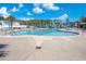 Resort style community pool with clear blue water surrounded by ample lounge chairs and palm trees at 730 Farrow Pkwy. # D, Myrtle Beach, SC 29577