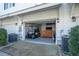 View of garage interior with a golf cart parked inside, leading to a cozy lounge area with a couch at 730 Farrow Pkwy. # D, Myrtle Beach, SC 29577