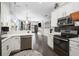This is a combined kitchen and living room space featuring black backsplash, white cabinets, and an open floor plan at 730 Farrow Pkwy. # D, Myrtle Beach, SC 29577