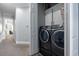 Convenient laundry room featuring a modern washer and dryer set with cabinets for storage at 730 Farrow Pkwy. # D, Myrtle Beach, SC 29577