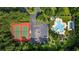 Aerial view showcasing community amenities, including a tennis court, pool, and parking at 765 Pinehurst Ln. # 96-C, Pawleys Island, SC 29585