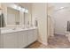 Bright bathroom with dual sinks, large mirrors, and tile flooring at 765 Pinehurst Ln. # 96-C, Pawleys Island, SC 29585