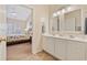 Well-lit bathroom with double sinks and a view into the main bedroom at 765 Pinehurst Ln. # 96-C, Pawleys Island, SC 29585