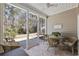 Inviting screened porch with stylish outdoor furniture, perfect for relaxation and enjoying nature at 765 Pinehurst Ln. # 96-C, Pawleys Island, SC 29585