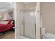 Bathroom featuring a glass shower stall, toilet, and adjacent bedroom at 822 Foxtail Dr. # 822, Longs, SC 29568