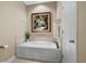 Bathtub in bathroom with decorative painting and neutral tiling at 822 Foxtail Dr. # 822, Longs, SC 29568