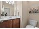 Small bathroom featuring a white toilet, modern light fixture, and decorative art at 822 Foxtail Dr. # 822, Longs, SC 29568
