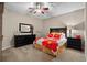 Spacious bedroom with bright, floral bedspread, ceiling fan, and black dresser at 822 Foxtail Dr. # 822, Longs, SC 29568