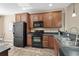 A kitchen featuring sleek black appliances and ample cabinet space with tile floors at 822 Foxtail Dr. # 822, Longs, SC 29568