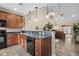 Well-lit kitchen with wood cabinets, black appliances, and adjacent open-plan living area at 822 Foxtail Dr. # 822, Longs, SC 29568