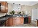 Kitchen view with wood cabinets, black appliances, bar top, and connecting living areas at 822 Foxtail Dr. # 822, Longs, SC 29568