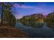 Breathtaking lake view with a tree-lined shore and the silhouette of a house, creating a peaceful ambiance at 822 Foxtail Dr. # 822, Longs, SC 29568
