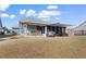 Backyard featuring a screened porch with a hot tub and a grill at 900 Pelagic Loop, Myrtle Beach, SC 29579