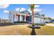 Inviting exterior featuring a well-maintained lawn, palm tree, and a charming front porch with flags at 900 Pelagic Loop, Myrtle Beach, SC 29579