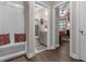 Hallway with built in bench leads to a full bath and cozy bedroom in neutral colors at 900 Pelagic Loop, Myrtle Beach, SC 29579