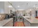 Bright kitchen with stainless appliances, granite countertops, an island with sink, and open dining area at 900 Pelagic Loop, Myrtle Beach, SC 29579