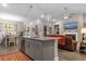 Open-concept living area features a kitchen island, pendant lighting, and a view of the fireplace at 900 Pelagic Loop, Myrtle Beach, SC 29579