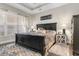 Comfortable primary bedroom showcasing tray ceiling, a black bed frame and matching bedside tables at 900 Pelagic Loop, Myrtle Beach, SC 29579