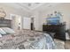 Well decorated primary bedroom provides a relaxing haven complete with a mounted television at 900 Pelagic Loop, Myrtle Beach, SC 29579