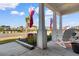 Welcoming front porch featuring rocking chairs, decorative flags, and manicured landscaping at 900 Pelagic Loop, Myrtle Beach, SC 29579