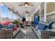 Comfortable sun room with wicker furniture, an area rug, and lots of natural light at 900 Pelagic Loop, Myrtle Beach, SC 29579