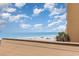 Beautiful oceanfront beach view from rooftop featuring light blue skies and fluffy white clouds at 9550 Shore Dr. # 231, Myrtle Beach, SC 29572