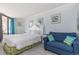 Bright bedroom with a queen bed, a cozy blue seating area, and balcony access at 9550 Shore Dr. # 231, Myrtle Beach, SC 29572