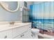 Cozy bathroom with a vanity, toilet, and beach-themed shower curtain at 9754 Leyland Dr. # 11, Myrtle Beach, SC 29572