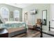 Bright bedroom featuring wood floors, two arched windows, and a mounted flatscreen TV at 9754 Leyland Dr. # 11, Myrtle Beach, SC 29572