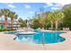 Inviting community pool surrounded by palm trees and lounge chairs at 9754 Leyland Dr. # 11, Myrtle Beach, SC 29572