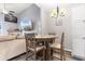 Open-concept dining area with comfortable seating, hardwood floors, and stylish light fixture at 9754 Leyland Dr. # 11, Myrtle Beach, SC 29572