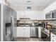 Modern kitchen featuring stainless steel appliances, granite countertops, and white cabinetry at 9754 Leyland Dr. # 11, Myrtle Beach, SC 29572
