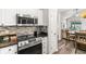 Updated kitchen showcasing stainless steel appliances and adjacent dining area at 9754 Leyland Dr. # 11, Myrtle Beach, SC 29572