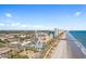 Aerial view of Myrtle Beach oceanfront featuring the SkyWheel, coastline, and city skyline against a clear blue sky at 1202 Formby Ct., Myrtle Beach, SC 29588