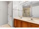 Bathroom featuring double sinks, wooden cabinetry, a large mirror, and a walk in shower with glass door at 1202 Formby Ct., Myrtle Beach, SC 29588