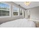Bright bedroom featuring three large windows, neutral walls, and a ceiling fan at 1202 Formby Ct., Myrtle Beach, SC 29588