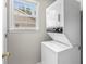 This laundry room features a stackable washer and dryer, maximizing space with a window to provide natural light at 1202 Formby Ct., Myrtle Beach, SC 29588