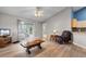 Living room featuring vaulted ceilings, ceiling fan, wood floors, and a sliding glass door to the bedroom at 1202 Formby Ct., Myrtle Beach, SC 29588