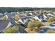 Aerial view of a residential neighborhood showcasing well-kept homes, mature trees, and green lawns at 133 Hartwell Dr., Little River, SC 29566