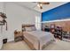 Cozy bedroom with comfortable bed, ceiling fan, natural light and wood-paneled accent wall at 133 Hartwell Dr., Little River, SC 29566