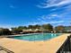 Outdoor community pool with light blue water, surrounded by a concrete deck and lush green landscape at 133 Hartwell Dr., Little River, SC 29566