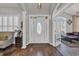Bright foyer with hardwood floors, a decorative front door, and views into the living spaces at 133 Hartwell Dr., Little River, SC 29566