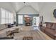 Bright living room featuring a fireplace, vaulted ceilings, and access to the backyard at 133 Hartwell Dr., Little River, SC 29566