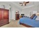 Spacious main bedroom with a large bed, walk in closet, ceiling fan, and a dedicated workspace at 133 Hartwell Dr., Little River, SC 29566
