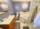 Bathroom featuring a soaking tub, vanity with storage, and tiled walls at 1356 Glenns Bay Rd. # 201B, Surfside Beach, SC 29575