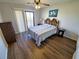 Bedroom with wood floors, ceiling fan, and sliding glass door to outdoor space at 1356 Glenns Bay Rd. # 201B, Surfside Beach, SC 29575