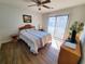 Bright bedroom with wood floors, ceiling fan, and sliding glass door to outdoor space at 1356 Glenns Bay Rd. # 201B, Surfside Beach, SC 29575