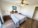 Cozy bedroom featuring a ceiling fan, wood-look flooring and a comfortable queen-sized bed at 1356 Glenns Bay Rd. # 201B, Surfside Beach, SC 29575